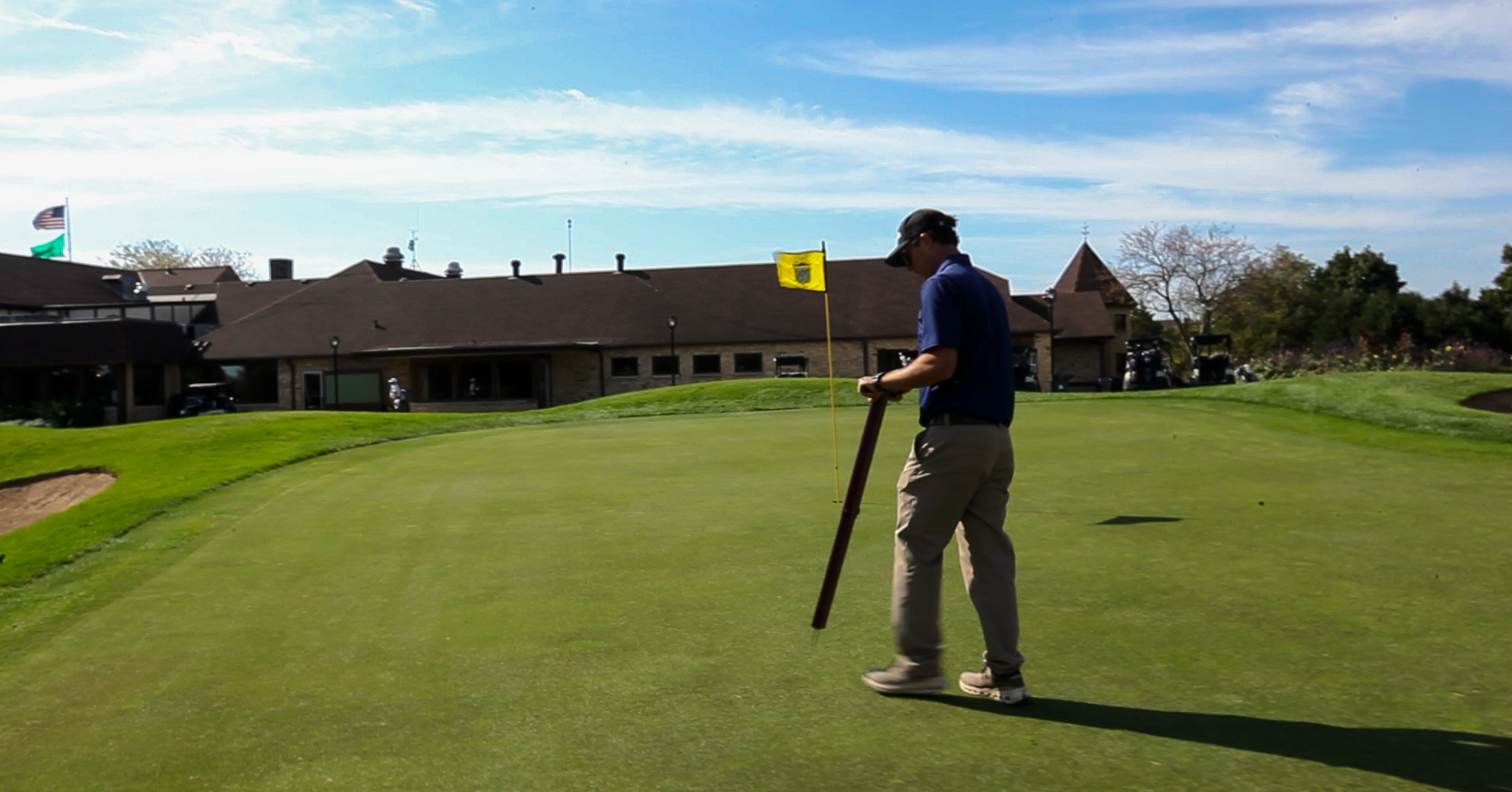 Matt Shafer checks turf conditions on the 18th green at North Hills Country Club in Menomonee Falls, Wisconsin.